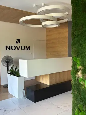 a lobby with a nokun sign and a chandelier at Aparthotel Rakowicka - Kraków Stare Miasto in Kraków