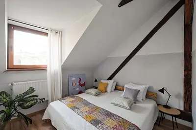 a bedroom with a bed with pillows on it at Urbannest-Augustiańska 4 in Kraków