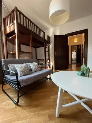 a living room with a bunk bed and a table at Spacious Flat in Kraków