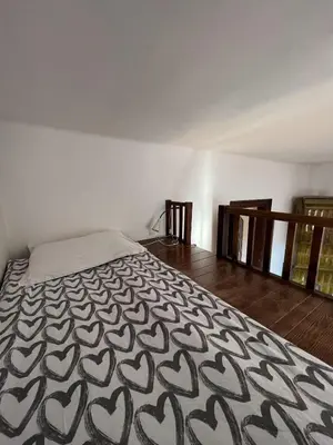 a bedroom with a bed with a black and white blanket at Spacious Flat in Kraków