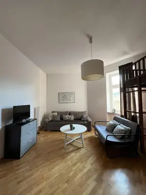a living room with a couch and a table at Spacious Flat in Kraków