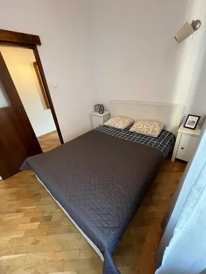 a bedroom with two beds and two night stands at Spacious Flat in Kraków