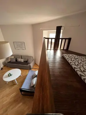 a living room with a couch and a table at Spacious Flat in Kraków