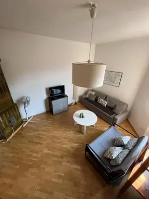 a living room with a couch and a table at Spacious Flat in Kraków