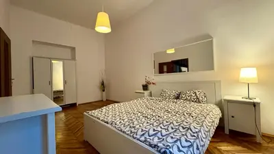 a bedroom with a large bed and a mirror at Next to Main Square in Kraków