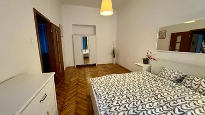 a bedroom with a bed and a mirror on the wall at Next to Main Square in Kraków