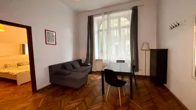 a living room with a couch and a table and a bed at Next to Main Square in Kraków
