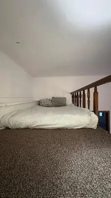 a bed in a bedroom with a wooden headboard at Next to Main Square in Kraków