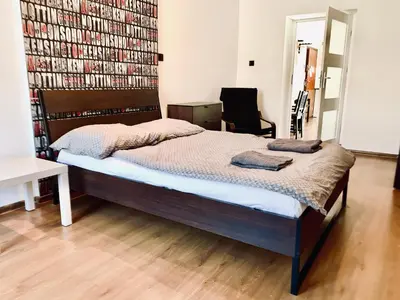 a bedroom with a bed and a large book wall at Św Sebastiana 20 in Kraków