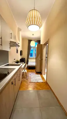 a kitchen with a sink and a refrigerator at Św Sebastiana 20 in Kraków