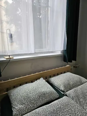 a bedroom with two beds and a window at Top Apartment in Kraków