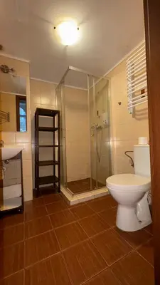 a bathroom with a shower and a toilet and a sink at Next to Main Square 2 in Kraków