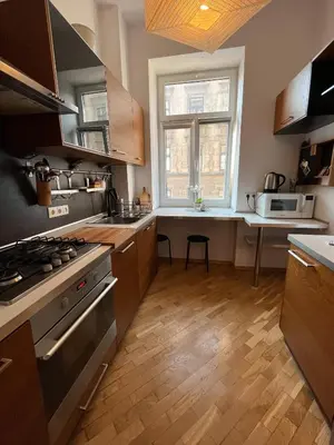 a kitchen with a stove and a sink and a window at Apt for six in Kraków