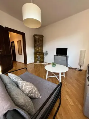 a living room with a couch and a table at Apt for six in Kraków