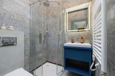 a bathroom with a blue sink and a shower at Kazimierz- Augustiańska 1- Studio with AC in Kraków