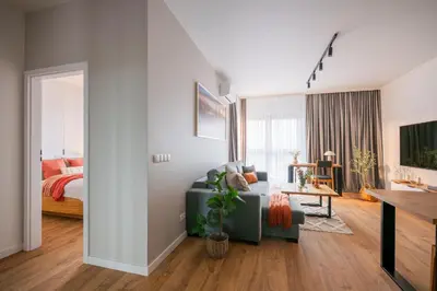 a living room with a couch and a bedroom at Apartamenty Lew Invest obok Rynku Głównego 255, Parking w cenie in Kraków