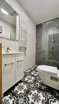 a bathroom with a tub and a sink and a shower at Small Apartment in Kraków