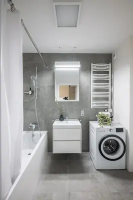 a bathroom with a washing machine and a sink at Apartamenty w centrum Krakowa, parking w cenie in Kraków