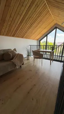 a living room with a couch and a table at Green Garden Zielonki 14e in Bibice
