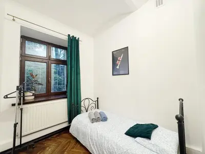 a bedroom with two beds and a window at Tawerna Krakowska in Kraków