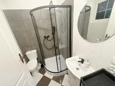 a bathroom with a shower and a toilet and a sink at Tawerna Krakowska in Kraków