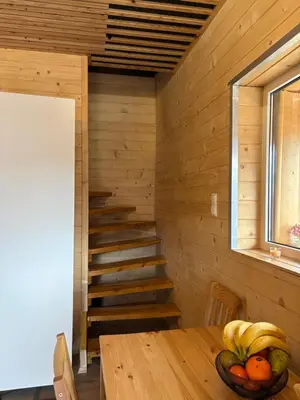 a attic bedroom with two beds and a table at Zacisze z Balia in Łostówka