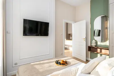 a living room with a television and a bowl of fruit at 2x Perfect Apartment OLD TOWN 5min Main Market Square AC WiFi Parking Balcony in Kraków