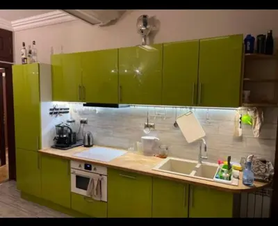 a kitchen with green cabinets and a sink at 5 min from city center by feet in Kraków