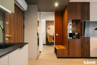 a dining room with a table and a mirror at Smolensk Loft Suite - homfi Collection in Kraków