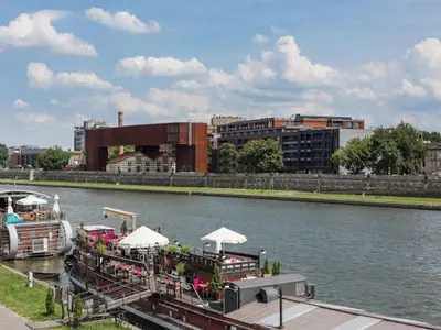 an overhead view of a group of buildings next to the water at Apartament nad Wisłą in Kraków
