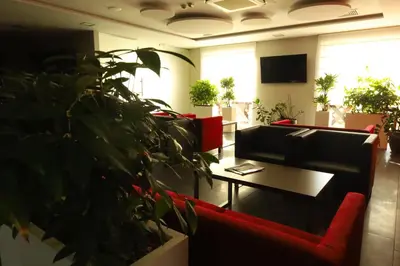 a hotel room with two beds and a desk at Hotel Radocza Park Business & Spa in Radocza