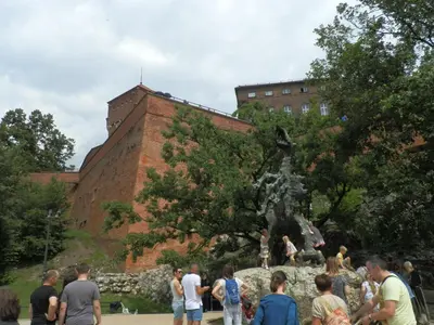 a group of people standing around a statue in front of a building at Studio Na Powiślu in Kraków