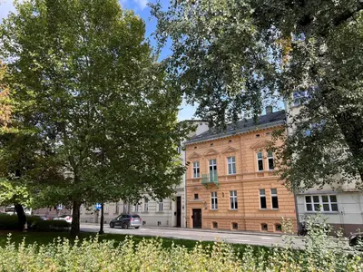 a large brick building with a car parked in front of it at Yourplace M57 Apartments in Kraków