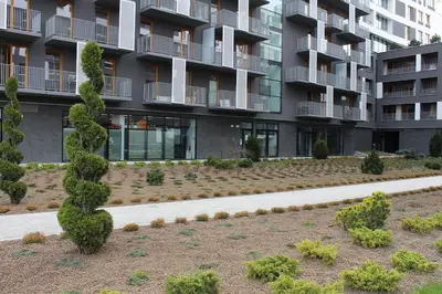 a garden in front of a apartment building at Przy Mocaku II in Kraków