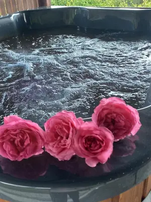 a cake with pink flowers on top of a table at domek simonka zawoja in Zawoja