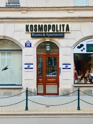 a store front with a wooden door on a building at Kosmopolita Apartments in Kraków