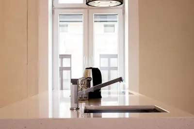 a kitchen with a sink and a window at Sauna Luxurious Apartment in Kraków