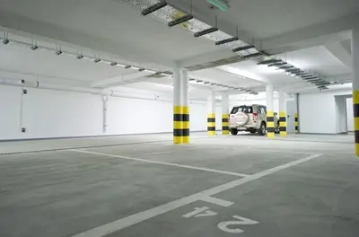 an empty parking lot with a car parked in it at 3D Szlak 77 Apartament in Kraków