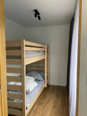 a bedroom with bunk beds in a room at Dom pod orzechem in Spytkowice