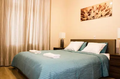 a living room with a bed and a dining room at Wild Solutions Sauna Apartments in Kraków