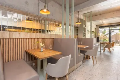a restaurant with wooden tables and chairs and tablesktop at River Side Residence nr 1m7 in Oświęcim