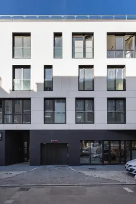 an empty parking lot in front of a white building at City of the Kings-Silver Apartment No 2- Lubelska 10 in Kraków