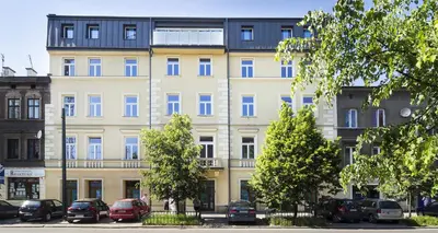 a large building with cars parked in front of it at TCF Home - Big Apartment with Free Garage in Kraków
