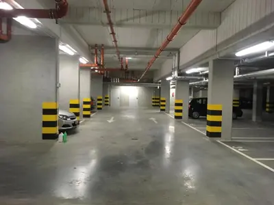 an empty parking garage with cars parked in it at NavyBlue apartment Cracow free parking TV in Kraków