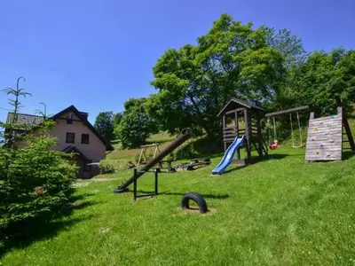 a park with a playground with slides and a play structure at Stodoła Simonka na punkcie widokowym in Zawoja