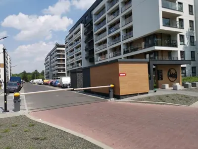 a parking lot in front of a large building at Apartament Kraków Arena in Kraków