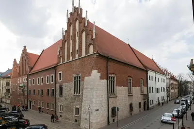 a large brick building with a steeple on a street at Belle Epoque II, luxury suite 50m to Main Square in Kraków