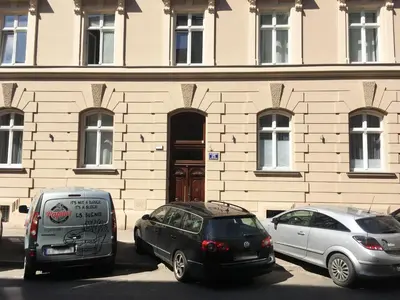 two cars parked in front of a building at Luxury Gold Cracow City Centre 3min Main Sq Old Town in Kraków