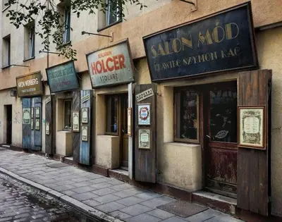 a building with many signs on the side of it at Beautiful apartment with air conditioning, balcony and underground garage in Kraków