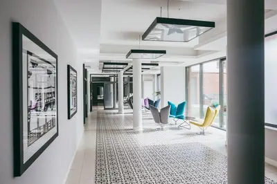 a hallway with chairs and pictures on the walls at Harmo Old Town with Spacious Sunny Terrace in Kraków